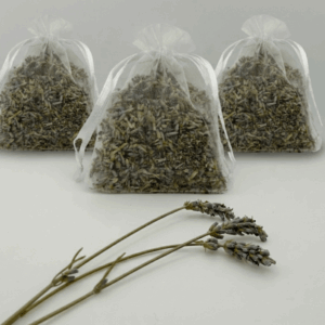 three lavender sachets from moment lavender on white background, which three sprigs of fresh lavender